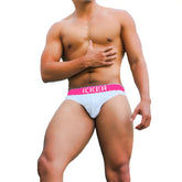 White briefs with bright pink waistband featuring icker logo in bold white letters from icker sea kiss my ass brief underwear fuchsia
