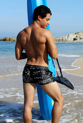 Icker Sea Letters square cut black swim trunks with white graffiti style print for stylish beachwear
