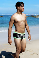 Icker Sea Letters square cut trunk swimwear in black and neon green with white graphic pattern for swimming