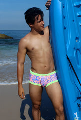Brightly colored icker sea letters square cut trunk swimwear with pink blue graphic pattern and neon green trim