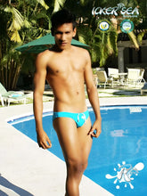 Icker Sea lifeguard jock brief swimwear in bright turquoise with a white logo on the front for beach use