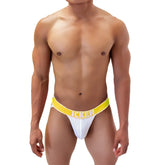 White mesh jockstrap with bright yellow waistband featuring icker brand name in bold white letters mango coI 21 06