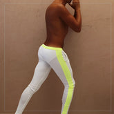 White athletic leggings with vibrant neon yellow side stripe and matching waistband from icker sea PN-18-01