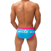 Bright blue icker sea smile me duotone brief underwear with bold pink trim and white cursive smile me script