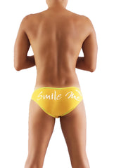 Bright yellow Icker Sea Smile Me slip bikini underwear with white smile me cursive script front design in mango color