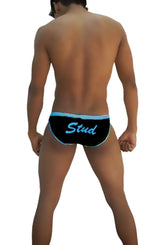 Black swim trunks with light blue trim and stud text in script font from icker sea slip bikini underwear collection