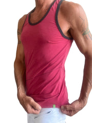 A fitted vibrant red tank top with black trim along neckline and armholes called the perfect tank raspberry