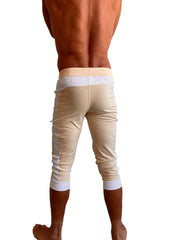 Beige capri edge cuffed yoga pants with white trim at waistband cuffs and side seams for activewear