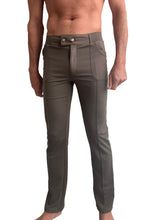 A pair of olive green tactical urban at home slim-fit dress yoga pants with structured waistband and gold buttons