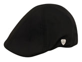 Black ivy cap with subtle texture and small silver shield emblem on the side made from soft fabric