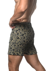 Olive green jacquard printed stretch knit shorts with black floral pattern and textured fabric front view