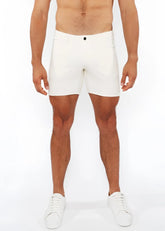 White jaquard stretch knit chino shorts with sleek form-fitting design and single black button at the waistband