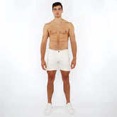 White jaquard stretch knit chino shorts with sleek minimalist design and a single black button at the waistband