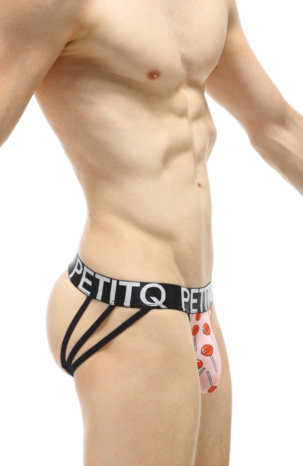 Pink lollipop-patterned petitq jockstrap with black elastic straps and branded waistband showing front view