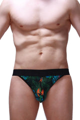 Black jockstring tropical briefs featuring a vibrant tropical leaf and bird pattern in green blue and orange colors