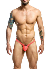 Bright coral mesh joe snyder bulge thong holes with black brand tag at front designed for support and comfort