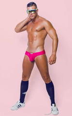 Bright pink joe snyder polyester mini cheek briefs with a snug form-fitting design shown from the back side