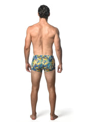 Men’s jungle printed swim trunk with vibrant tropical palm leaf pattern in yellow and blue for beachwear