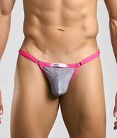 A vibrant pink and silver glitter thong bikini bottom with branded label from Justin plus Simon Bikini One
