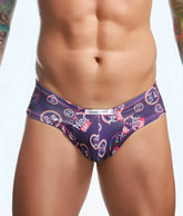 Purple swim trunks by justin simon with vibrant pride day rainbow hearts and cheek fun prints design