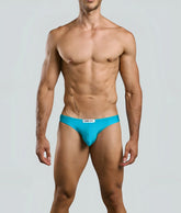 Bright turquoise men’s classic bikini briefs with white brand tag at waistband by justin + simon