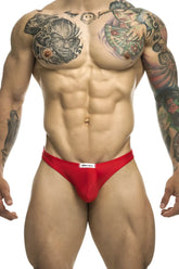 Red men’s briefs with a white brand label on the waistband from JUSTIN+SIMON XSJ03 classic thongs color red collection
