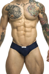 Navy blue Justin Simon XSJ22 cheek briefs with a white brand label on the waistband for athletic wear