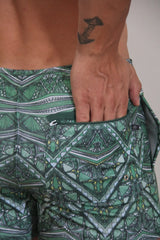 Kaleidoscope shorts green patterned swim trunks with geometric tribal designs in green black white and yellow