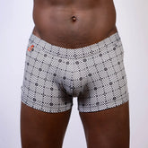 Kaleidoscope sq cut trunk boxer briefs with black and white geometric pattern and subtle orange logo waistband
