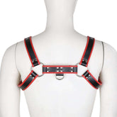 Mannequin's back wearing a black harness with red contrast trim and silver hardware.
