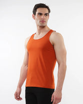 Orange sleeveless laser cut stretch jersey tank top showcasing breathable fabric and stylish design