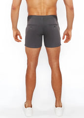 Dark gray linen-look textured tailored shorts with button back pockets and zip pockets shown from the back side