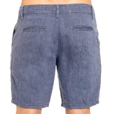 Blue linen slim fit shorts with a heathered denim look and subtle textured weave shown from the back side