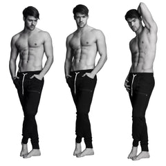 Black long cuffed jogger and yoga sweat pants with white drawstrings and side pockets made from soft fabric