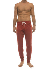 Red long cuffed jogger and yoga sweat pants in cinnabar with white drawstring waistband and side pockets