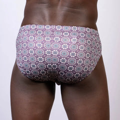 Mandala swim brief in purple and teal geometric floral pattern designed for comfortable swimwear use