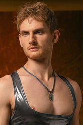 A MANstore Guywear necklace featuring a razor blade pendant worn by a man in a metallic tank top.