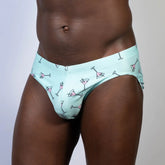 Mint green swim brief featuring a playful pink martini glass pattern perfect for stylish beachwear