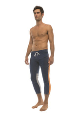 Mens royal navy blue capri yoga pants with orange and grey side stripes and 4/5 zipper pockets and drawstring waist