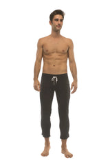 Men’s solid black capri yoga pants with white drawstring waistband side pockets and 4 5 zipper pockets