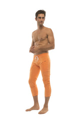 Mens solid orange athletic capri yoga pants with white drawstring waistband and 4/5 zipper pockets
