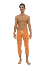 Mens 4/5 zipper pocket capri yoga pants in solid orange with white drawstring waistband for athletic use