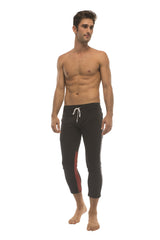 Mens black capri yoga pants with red side stripe white drawstring waistband and zipper pockets for active wear