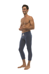 Mens solid royal blue capri yoga pants with white drawstring waistband and zipper pockets for active wear