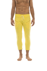 Bright yellow mens capri yoga pants with white drawstring waistband and diagonal zipper pockets in solid yellow