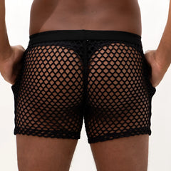 Black mesh swim trunks with a solid waistband shown from the back in the mesh back short style