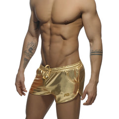 Shiny gold metallic swim trunks with drawstring waistband and side pockets in metallic short style