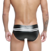 Black shiny faux leather swim trunks with white horizontal stripes on the waistband metroMalewear Alexander competition suit