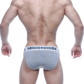Gray and white striped men’s briefs with a bold black logo waistband from metro malewear asian bikini 3004-46