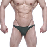 Dark green form-fitting thong briefs with a small white MetroMaleWear brand tag at the waistband from Asian Jock Strap 5001-26